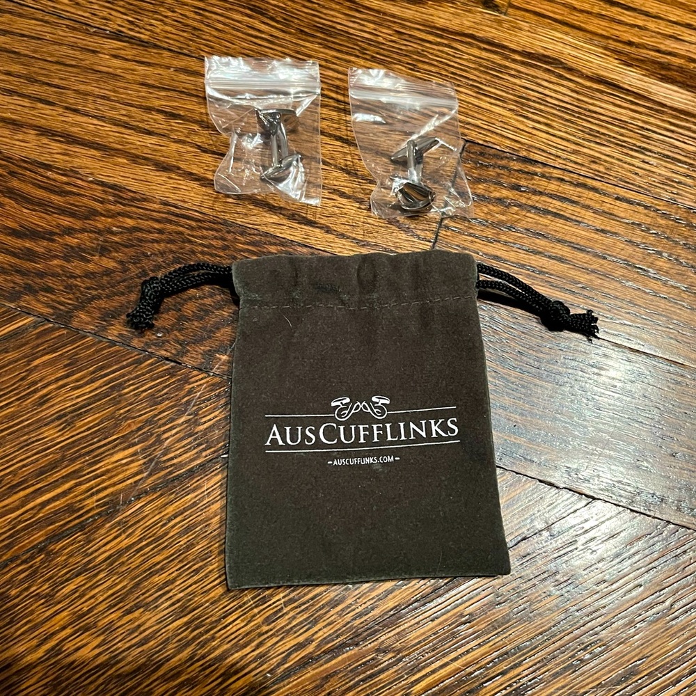 New. Silver sailboat cuff links with pouch.
